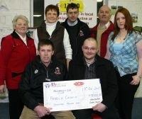 Club Treasurer Neilie McCarthy presents Patrick Cronin with his lotto winnings of 17,000.