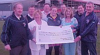 Mrs Marie Molly Recieving a cheque for 20,000 as winner of the Lotto Jackpot recently