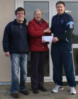Miche�l Briody, Chairman of St Brigid�s GFC presenting Tess Brady with her winning blotto cheque of �3,800 in January 2011. Also in picture is ticket seller Eamonn Tuite Junior