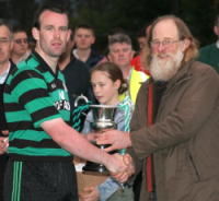 Johnny Murphy receives Lee Cup from Mossie Lee at opening of new field