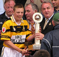 Keith Buckley accepts the Christy Ring Trophy from Uachtarain CLCG Nicky Brennan